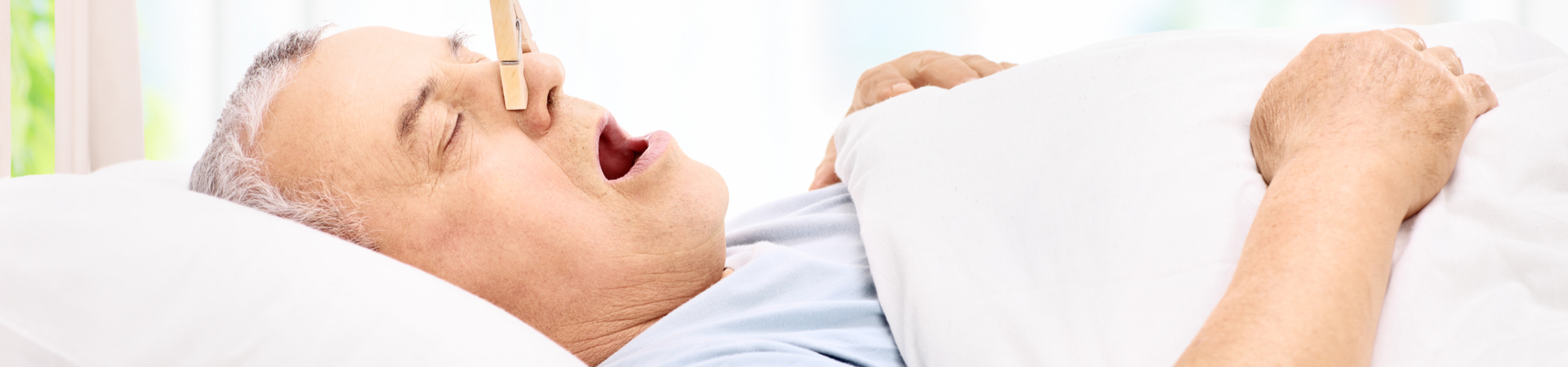 man snoring with nose plug