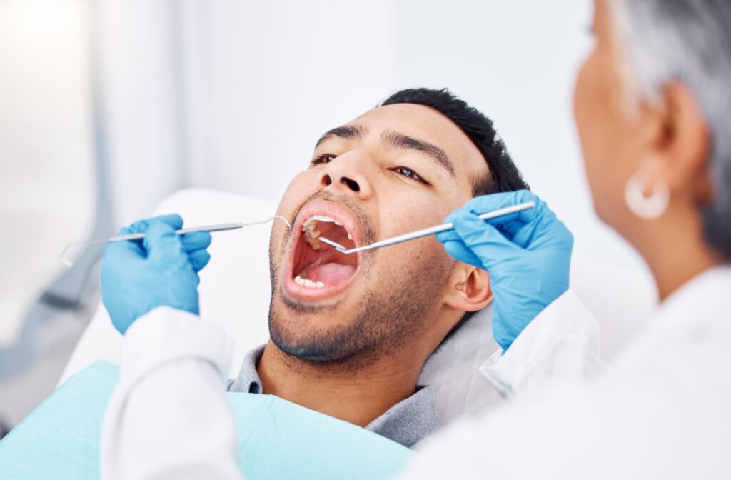 A young man getting a routine dental cleaning to help keep his breath fresh.