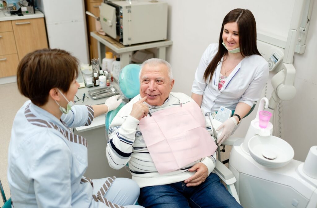 A patient discusses his options for replacing missing teeth with his dentist during a checkup